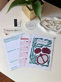 Between Lines Meal Planning Sheets flat lay showing weekly meal planner, grocery list, and decorative cover page with pomegranate illustration